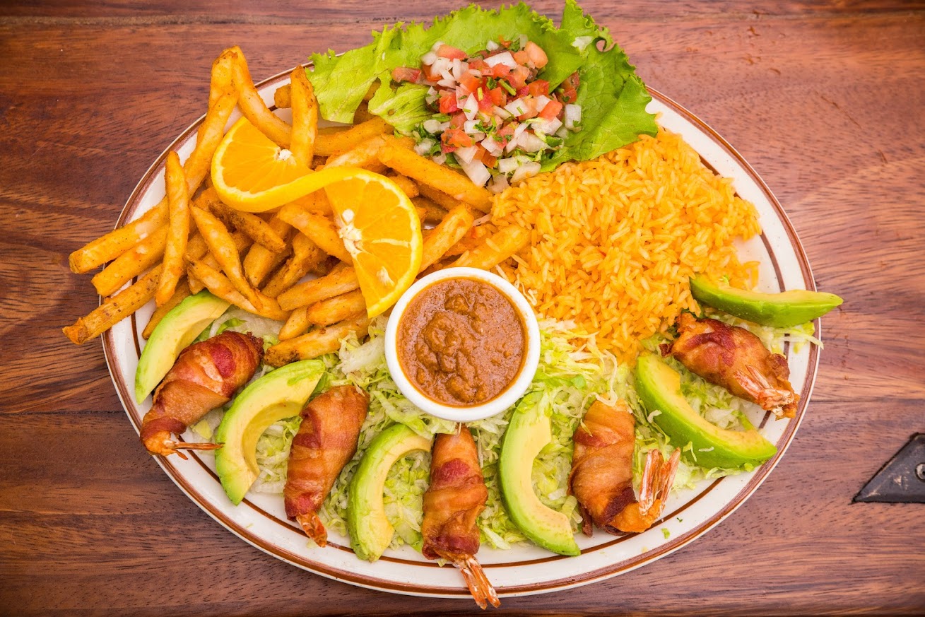 Grilled meat rolled with bacon, salad, mixed vegetables and rice on the side